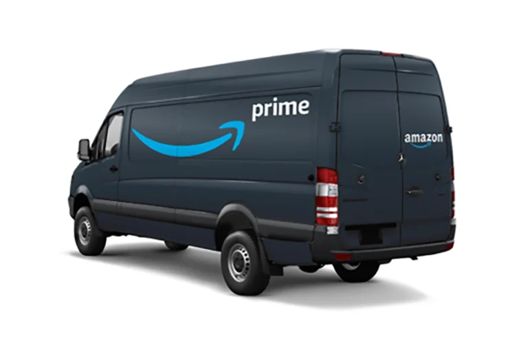 A dark blue Amazon Prime delivery van with the Amazon logo and "prime" text on the side, parked diagonally with its rear doors visible.