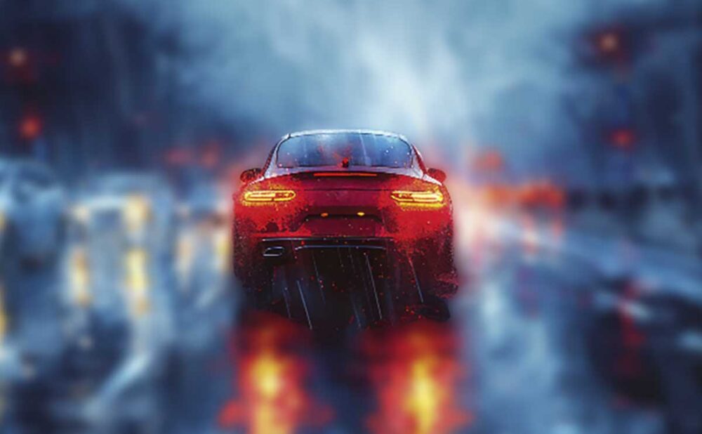 A red car navigates a slick, wet street at night, highlighting the risks of driving in inclement weather.