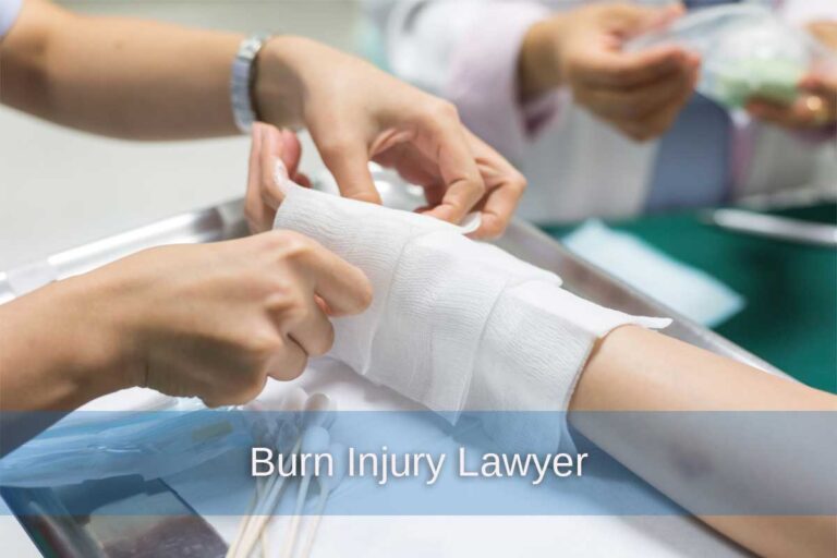 A medical professional carefully applies bandages to a patient's hand, highlighting the importance of proper care and legal support for burn injuries.