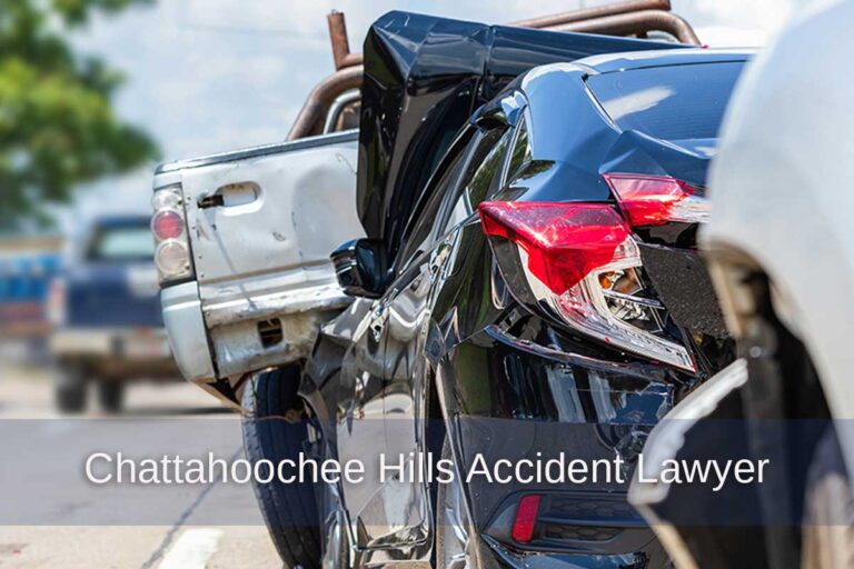 Auto accident involving a blue sedan and white truck on a road highlights the need for legal assistance from a Chattahoochee Hills car accident lawyer.