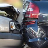 Close up of two damaged cars after a collision, highlighting the importance of maximizing settlement compensation for rear-end accidents.