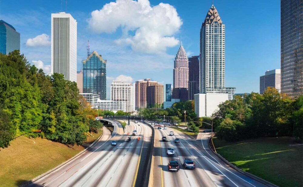 Scenic skyline of downtown Atlanta captured from an elevated highway, reflecting the hazards of urban driving conditions.