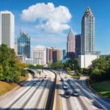 Scenic skyline of downtown Atlanta captured from an elevated highway, reflecting the hazards of urban driving conditions.