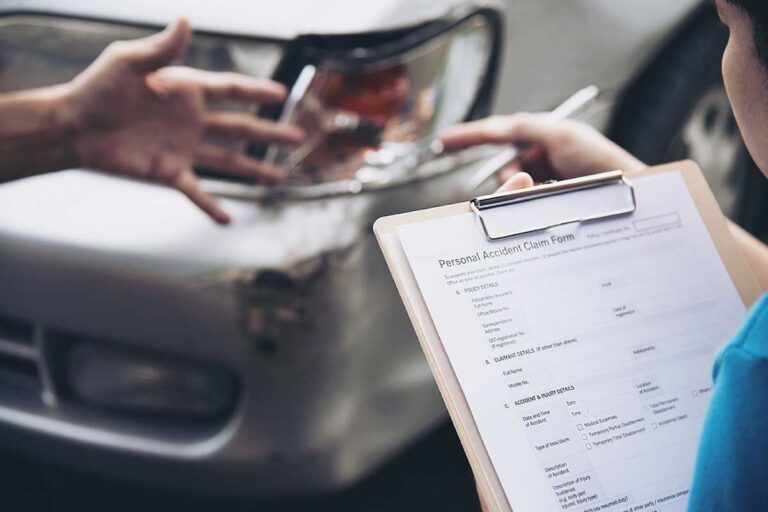 An insurance claimer holds a clipboard and documents a car accident, highlighting the challenges of establishing fault in multi-vehicle collisions.