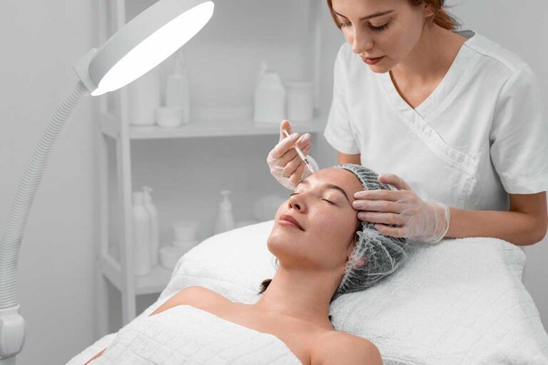 A beautician injects a woman with filler, highlighting the need for awareness of risks in cosmetic procedures.