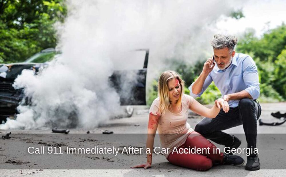 A man on a phone helps an injured woman after a crash, highlighting the need to call 911 immediately after a car accident in Georgia.