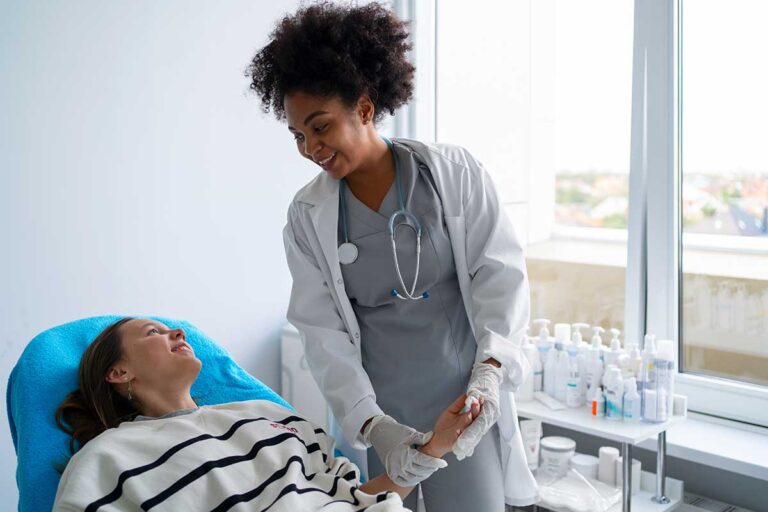 A doctor examines a female patient, emphasizing the importance of immediate medical care after an auto accident.