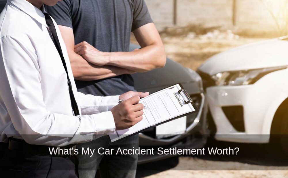 Insurance adjustor takes notes following a car crash as the victim contemplates the value of a car accident settlement.