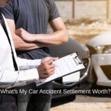 Insurance adjustor takes notes following a car crash as the victim contemplates the value of a car accident settlement.