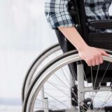 A person in a wheelchair confidently grips the wheel, symbolizing resilience in the face of catastrophic injuries in Georgia.