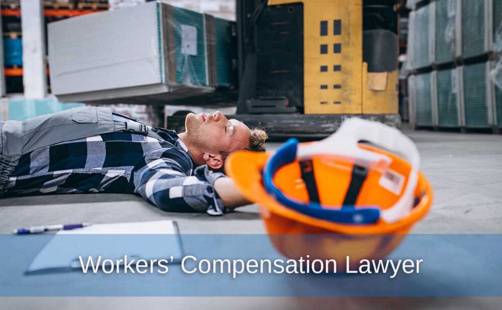 A man lies injured on a warehouse floor, illustrating the importance of hiring a Georgia workers' compensation lawyer.