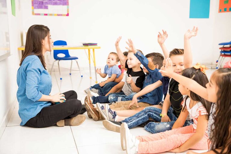 A teacher interacting with preschool children in a classroom, focusing on the critical issue of daycare abuse and neglect.