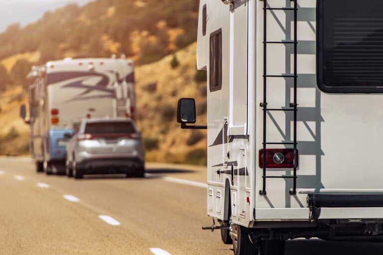 Two motorhomes travel down a highway, representing the process of navigating a large vehicle accident claim in Georgia.
