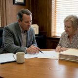 Attorney and client discuss documents in office