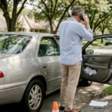 Man calling roadside after minor car accident