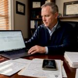 Man handling trucking crash insurance claim paperwork