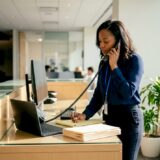 Intake specialist taking notes on phone call