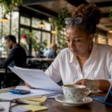 Woman reviewing insurance claim documents at desk