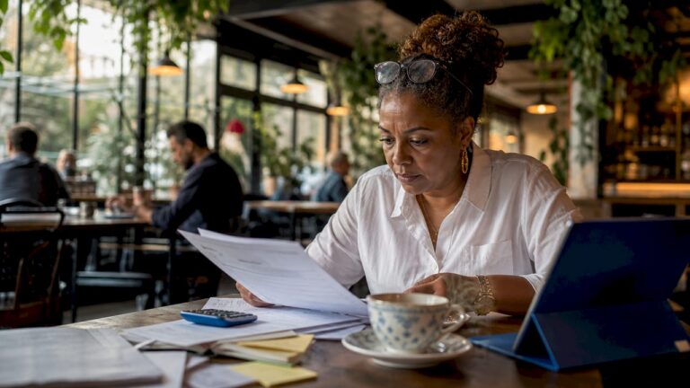 Woman reviewing insurance claim documents at desk