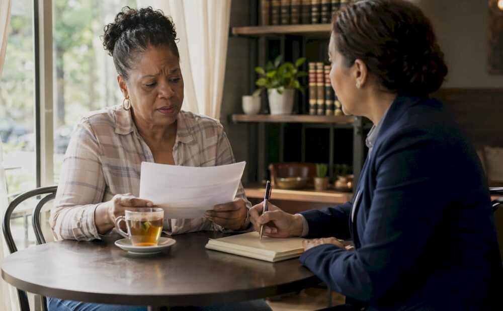 Accident victim consulting attorney in law office