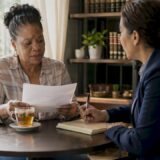Accident victim consulting attorney in law office