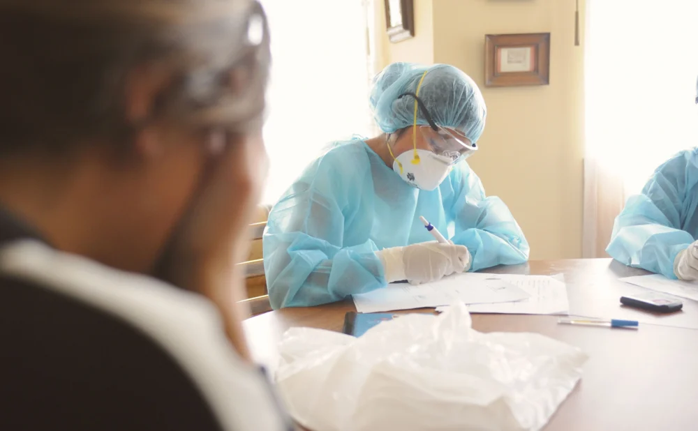 Georgia medical malpractice attorney reviewing medical records and settlement factors with an injured patient.