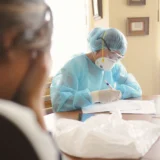 Georgia medical malpractice attorney reviewing medical records and settlement factors with an injured patient.