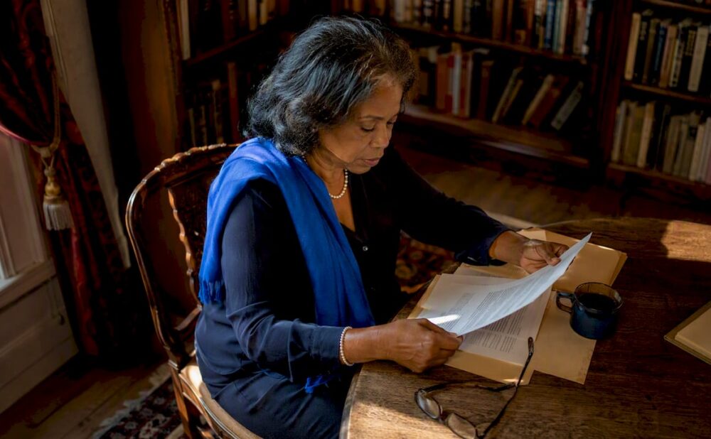 Woman reviewing legal papers at home table