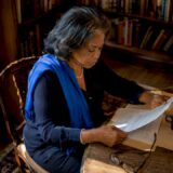 Woman reviewing legal papers at home table