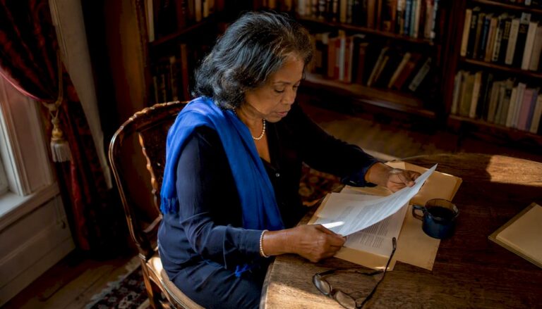 Woman reviewing legal papers at home table