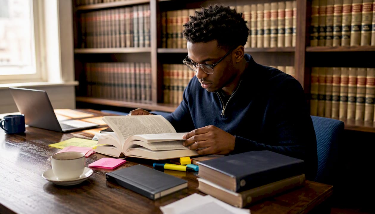 Law student studying civil and criminal law books