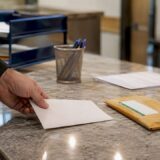 Hospital lien notice with certified mail on desk