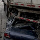 Damaged truck underride guard and crushed vehicle roof