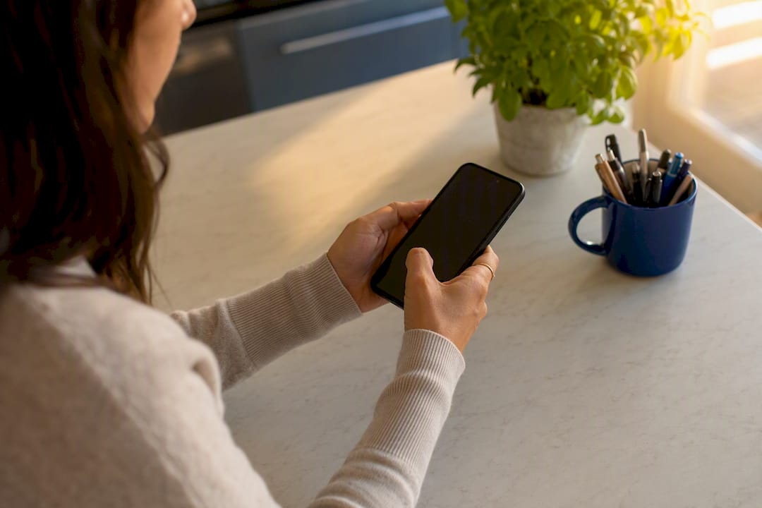 Hands typing email on smartphone