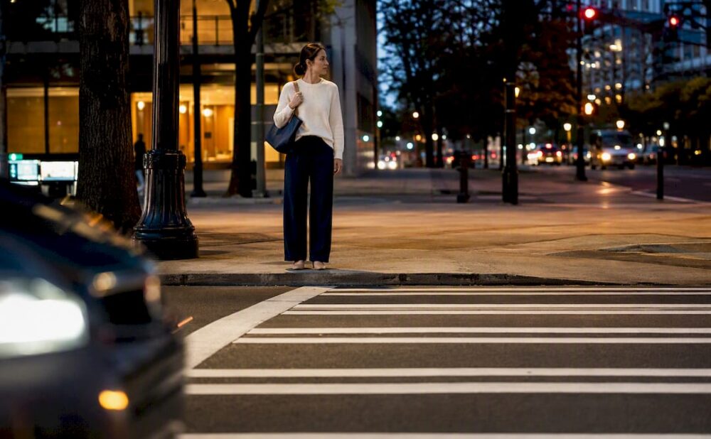 Pedestrian at Atlanta crosswalk during evening traffic
