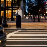 Pedestrian at Atlanta crosswalk during evening traffic
