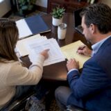 Attorney and client reviewing medical settlement bills