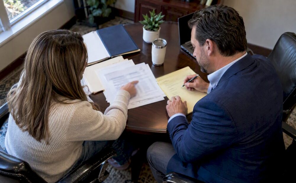 Attorney and client reviewing medical settlement bills